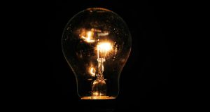 Lit incandescent light bulb with visible filaments