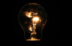 Lit incandescent light bulb with visible filaments
