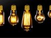 Different incandescent bulbs lined up, black background