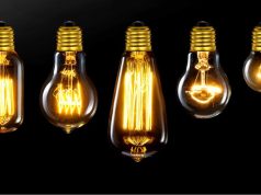 Different incandescent bulbs lined up, black background
