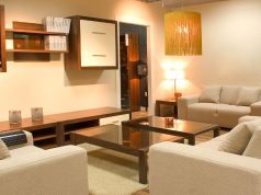 furnished living room with warm white light fixtures
