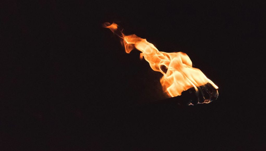 Black background with an image of a torch