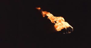 Black background with an image of a torch