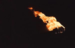 Black background with an image of a torch