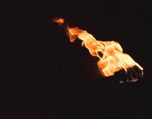 Black background with an image of a torch