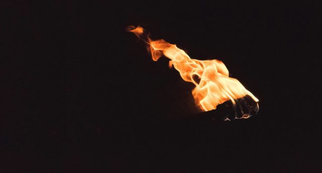 Black background with an image of a torch