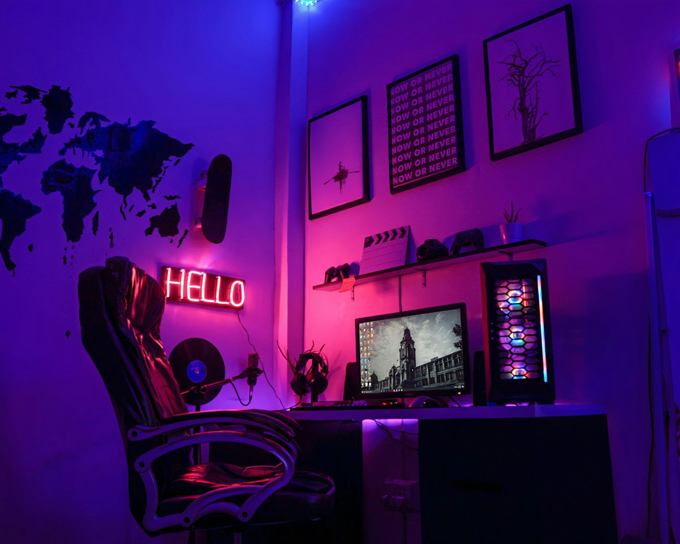 A PC gaming setup with blue ambient lighting and a red neon sign that says HELLO.