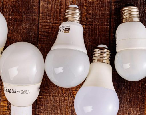Light bulbs alternately lined up on a table with labels showing on some