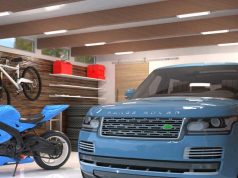 An image of a clean and bright garage with a motorcycle and a car parked inside.