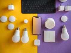 LED bulbs and other electronics laid out on a yellow and purple table.