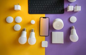 LED bulbs and other electronics laid out on a yellow and purple table.