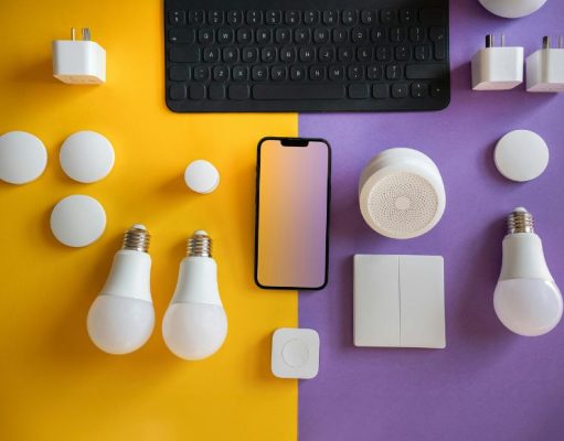 LED bulbs and other electronics laid out on a yellow and purple table.