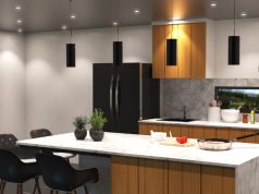 A kitchen with multiple downlight and four pendant lights.