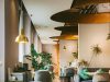 A brightly lit restaurant with brass fixtures and warm lighting.
