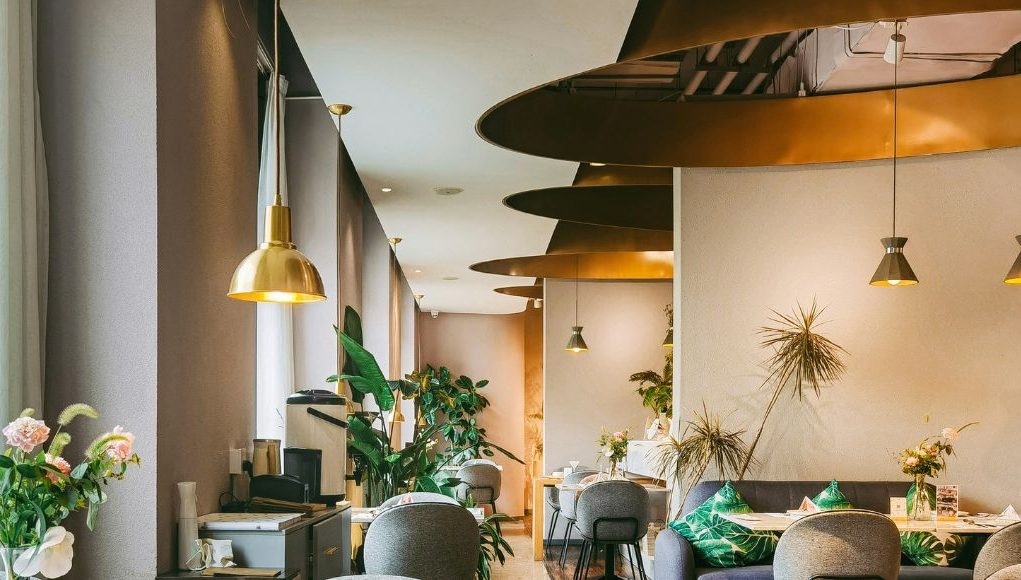 A brightly lit restaurant with brass fixtures and warm lighting.