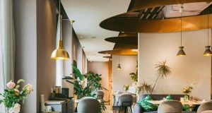 A brightly lit restaurant with brass fixtures and warm lighting.