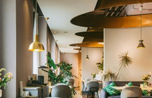 Lighting Quality & Visual Comfort: Creating Pleasing Commercial Interiors A brightly lit restaurant with brass fixtures and warm lighting.