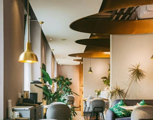 A brightly lit restaurant with brass fixtures and warm lighting.