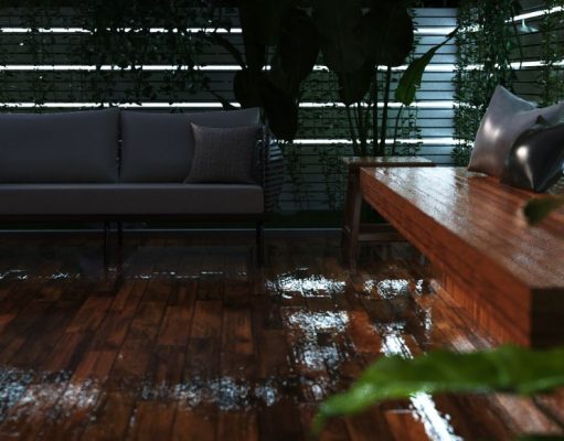 An outdoor deck that's wet from rain with multiple strip lighting on the perimeter wall.
