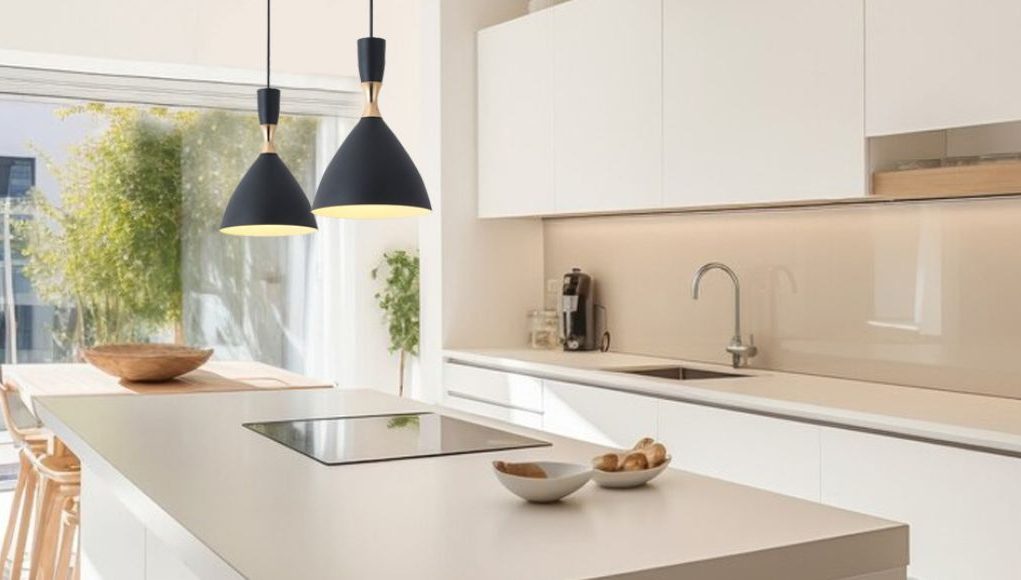 A modern kitchen with an island and two hanging pendants over it.