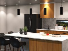 A modern kitchen with an island and multiple recessed ceiling lights and pendant lights hanging from the ceiling.