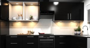 A kitchen with dark cabinet doors and warm lighting.
