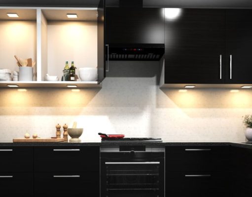 Modern Kitchen Lighting Trends for 2025 A kitchen with dark cabinet doors and warm lighting.