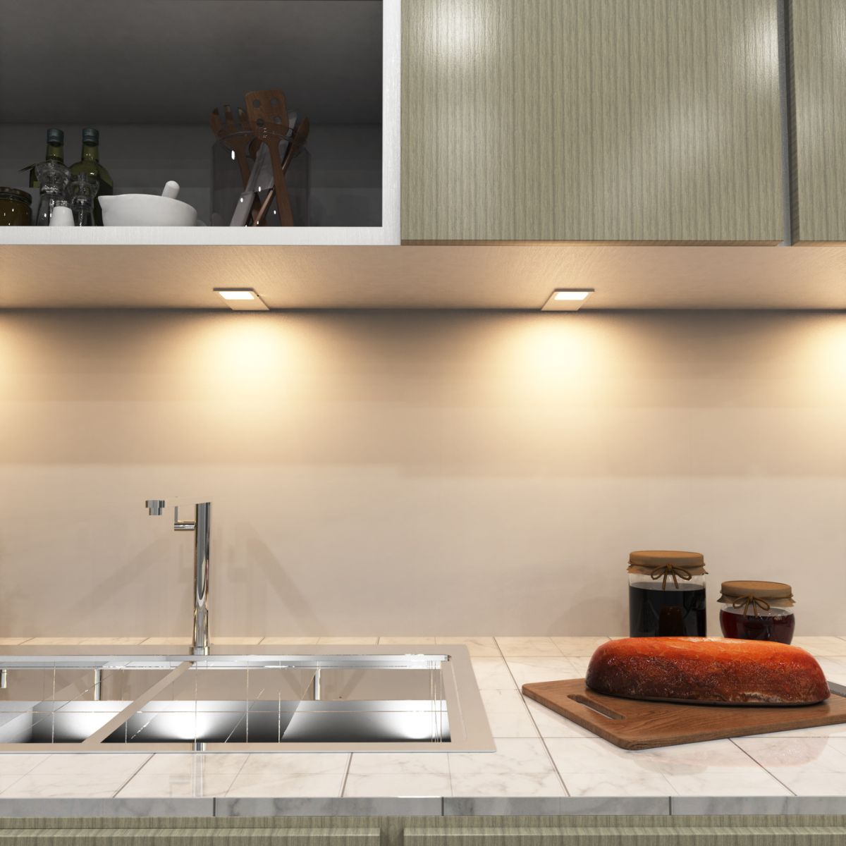 A kitchen countertop sink area with warm under-cabinet lighting.