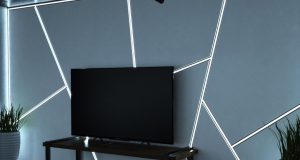 A living room TV with a feature wall with multiple LED strip lights installed in aluminium profiles.