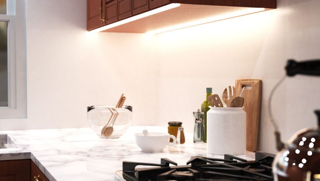 Lighting Mistake 1 A bright kitchen countertop with various kitchen stuff with under-cabinet strip lighting for illumination.