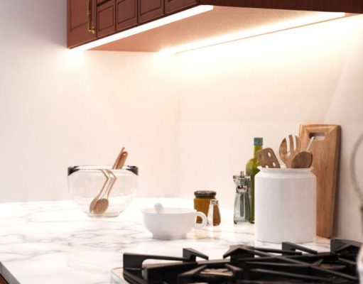 Kitchen Lighting Mistakes to Avoid A bright kitchen countertop with various kitchen stuff with under-cabinet strip lighting for illumination.