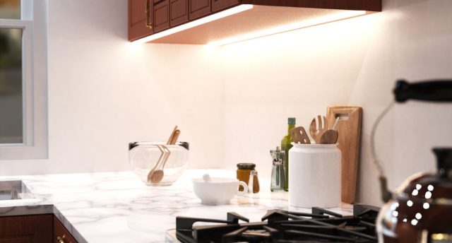 Kitchen Lighting Mistakes to Avoid A bright kitchen countertop with various kitchen stuff with under-cabinet strip lighting for illumination.