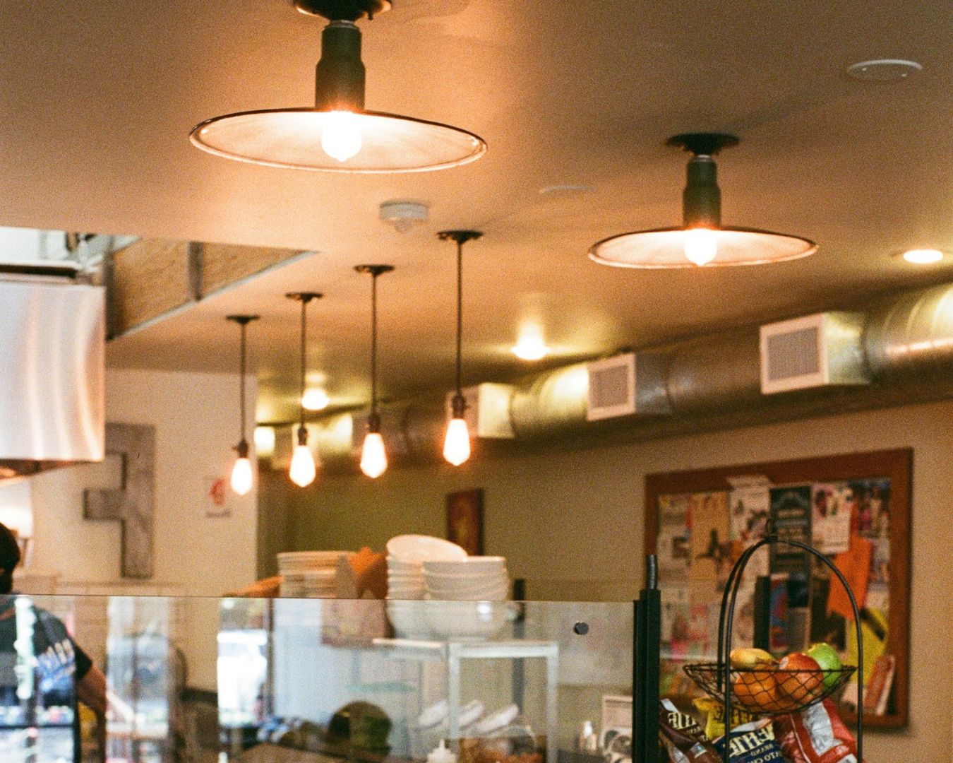 An inside of a commercial space with visible warm lights hanging from the ceiling.