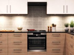 Small Kitchen Lighting Ideas to Maximise Space A modern kitchen with wooden cabinets and wall cabinets with lights.