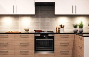 Small Kitchen Lighting Ideas to Maximise Space A modern kitchen with wooden cabinets and wall cabinets with lights.