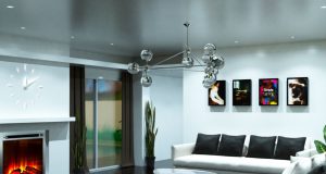 A living room with white sofa and black pillows and a silver hanging statement light.