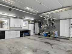 Storage & Shelving Lighting Ideas for Organised Garages A wide garage with a clean and organised shelving on the walls.