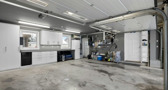 Storage & Shelving Lighting Ideas for Organised Garages A wide garage with a clean and organised shelving on the walls.