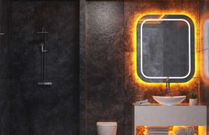 Creative LED Strip Lighting Ideas for Every Room in Your Home A dark bathroom with white sink and a mirror with orange backlighting.