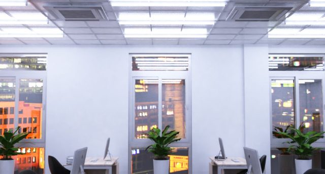 An office with windows overlooking a city, its ceiling is installed with multiple tube lights.