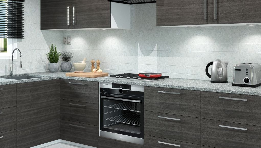 A modern kitchen with dark wood cabinets and white splashback.