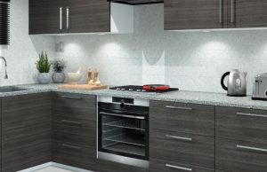 The Best Under-Cabinet Lighting for Kitchens A modern kitchen with dark wood cabinets and white splashback.