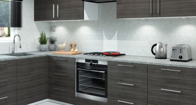 A modern kitchen with dark wood cabinets and white splashback.