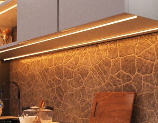 How to Use LED Strip Lights in Your Kitchen A kitchen countertop with visible under-cabinet LED strip lights with a warm glow.