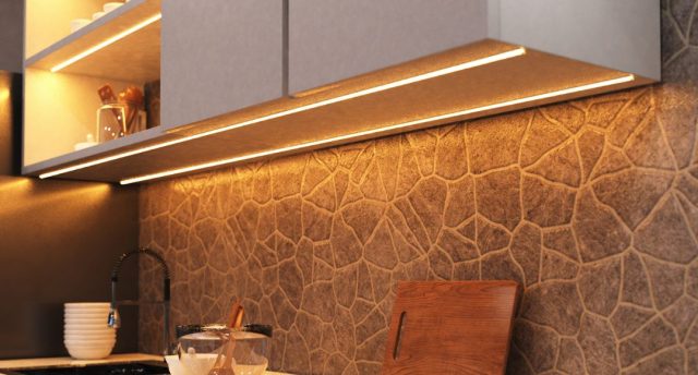 How to Use LED Strip Lights in Your Kitchen A kitchen countertop with visible under-cabinet LED strip lights with a warm glow.