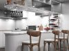 Create the Perfect Mood for Any Moment with Smart Lighting Automation A kitchen with a bar counter and three chairs beside it, multiple under cabinet lights are illuminating the space.