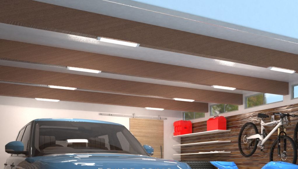 A garage ceiling with multiple batten lights installed on the exposed beams.