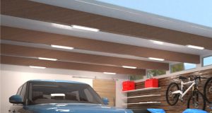 A garage ceiling with multiple batten lights installed on the exposed beams.