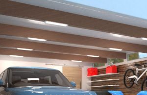 A garage ceiling with multiple batten lights installed on the exposed beams.