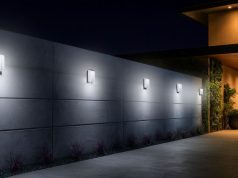 Best Outdoor Uses for LED Bulkhead Lights An outdoor wall of a modern home with five LED bulkhead lights installed and glowing with bright white light.